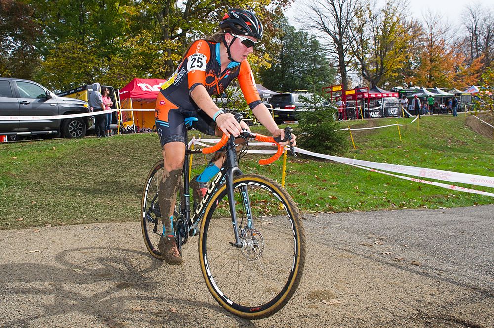 A Womens CX Project rider rounds a corner with two laps to go.