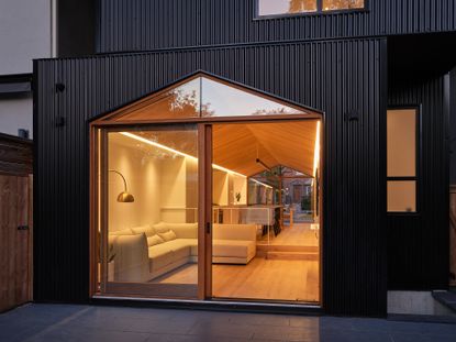 night time ground floor shot looking in at Everden house by archollab