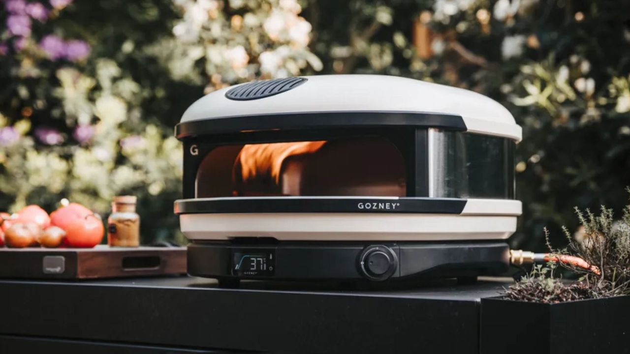 The Gozney Arc Pizza Oven, lit and being used to cook
