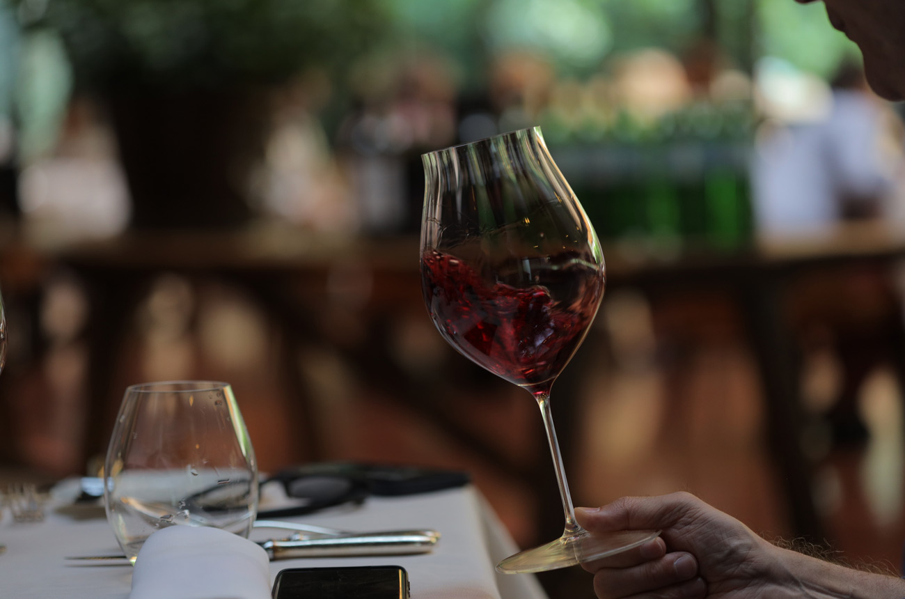 A glass of red wine being swirled