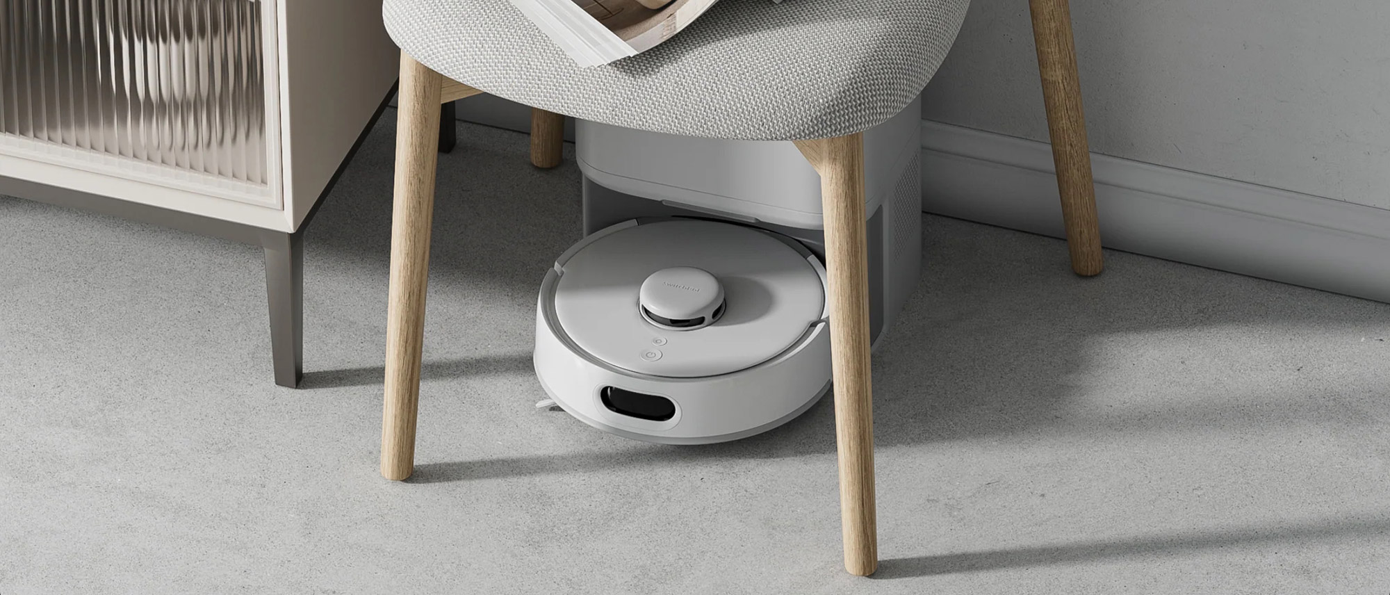 SwitchBot K10+ Pro robot vacuum under chair