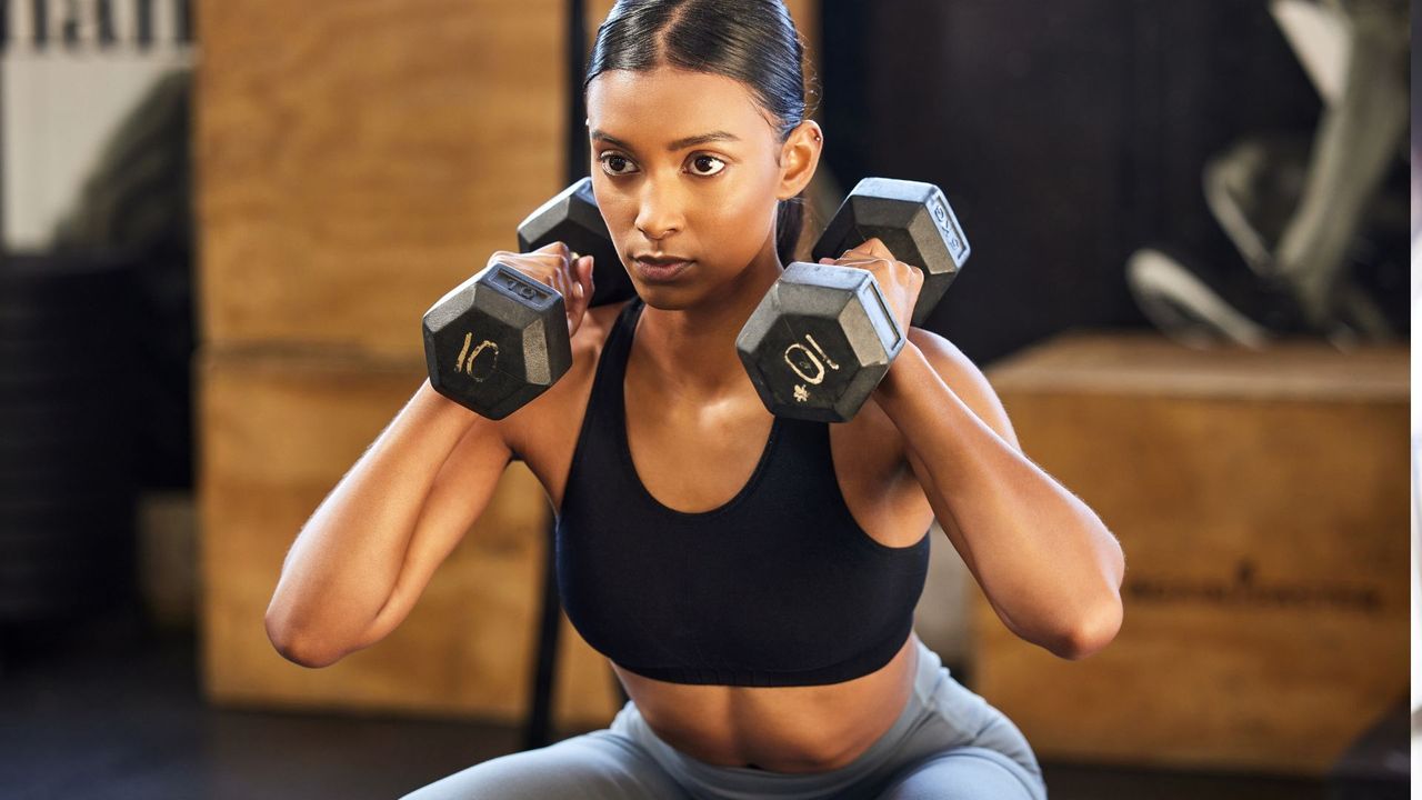 Woman doing dumbbell squat