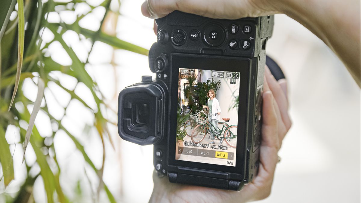 Nikon Z5 II camera in the hand, vertical, with creator recipe being selected on screen