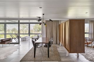 Broken plan modern living area divided by a midcentury cabinet
