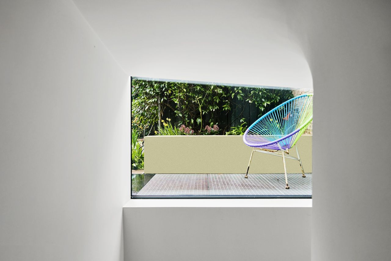 A view through a hatch in the bedroom shows a secret entrance to the garden
