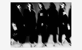 Models wearing a black tuxedo collection