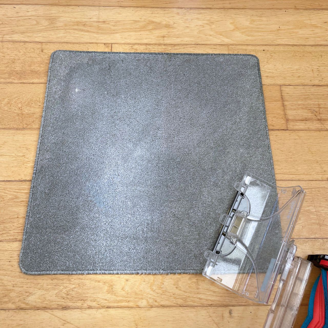 Grey carpet sample that has just been cleaned by a carpet cleaner