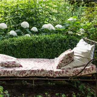 An antique day bed in a garden