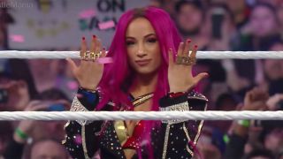 Sasha Banks entering the ring with pink hair.