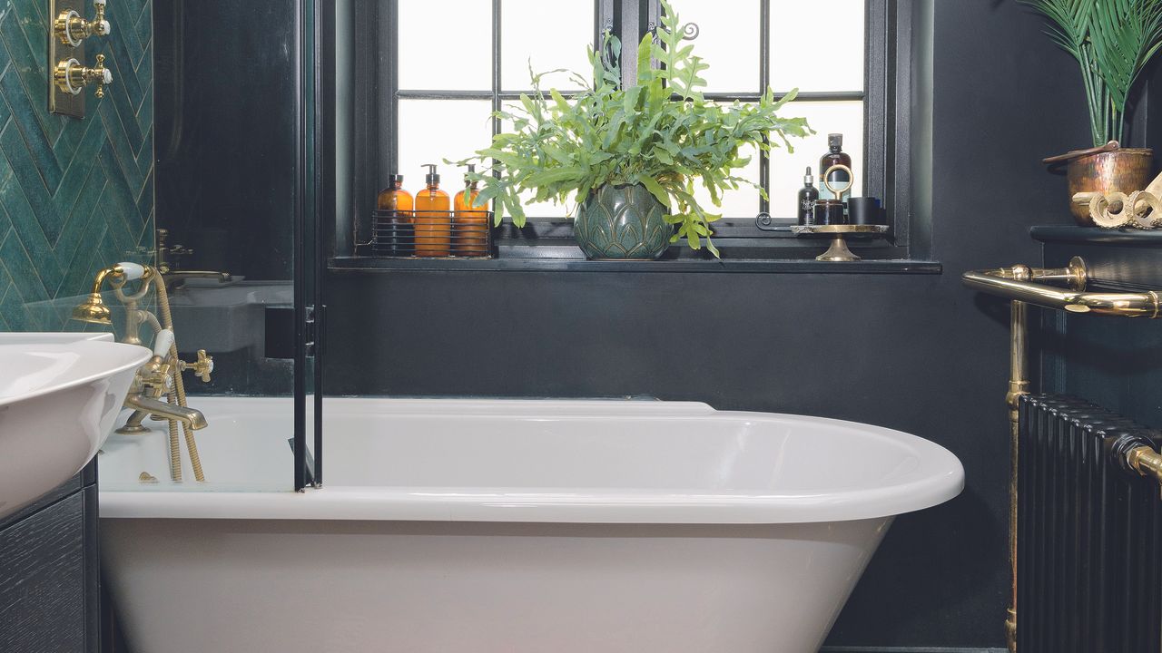 Black bathroom with white bath