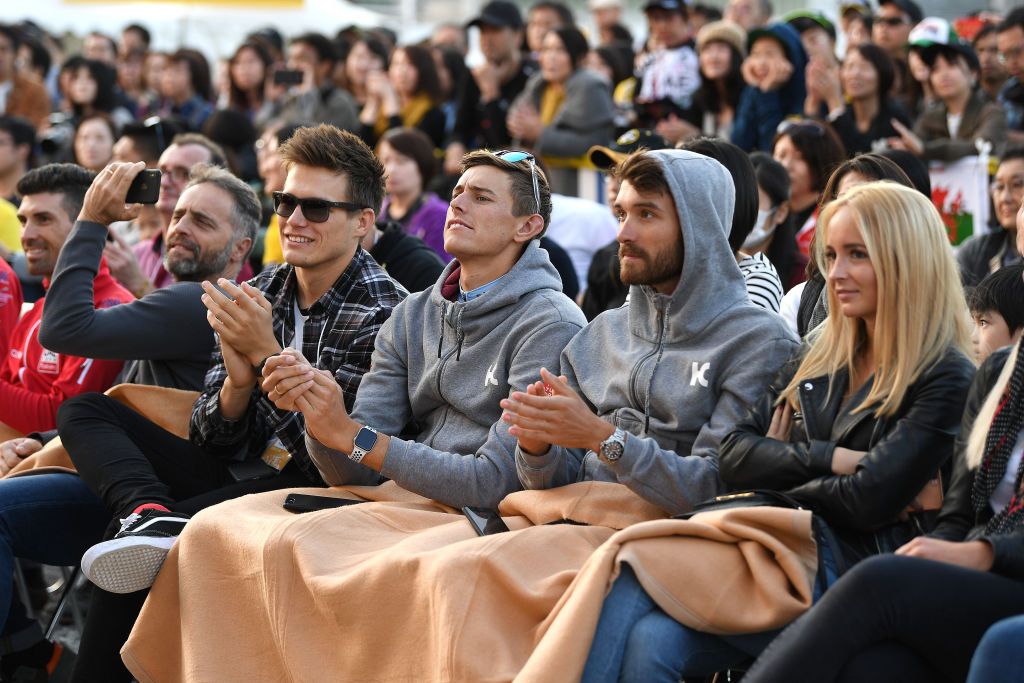 The riders keep warm as they watch the stage show