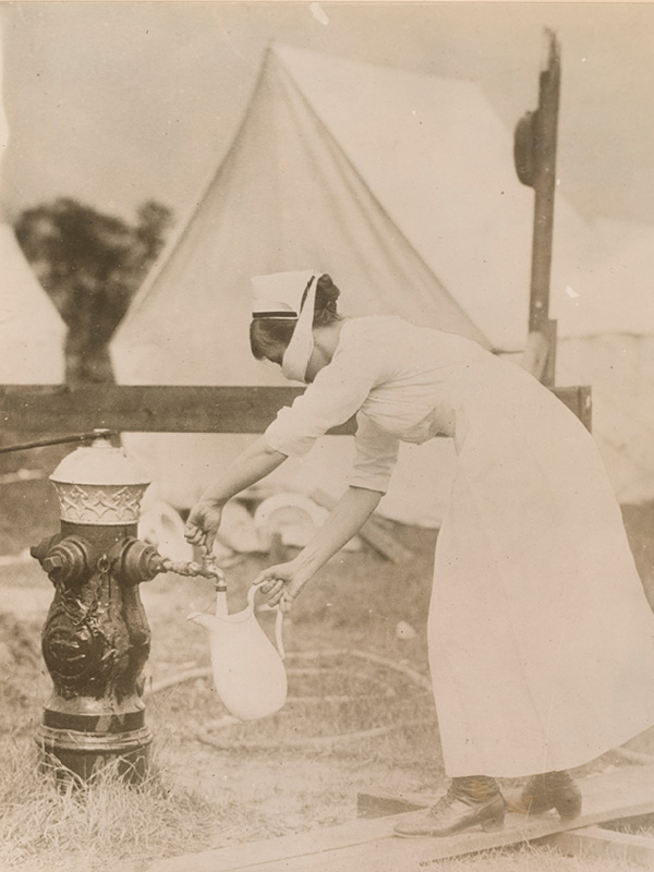 A nurse collects water wearing a mask as a protection against influenza