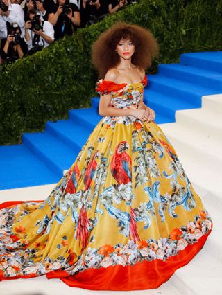 Zendaya wears a colorful voluminous gown.