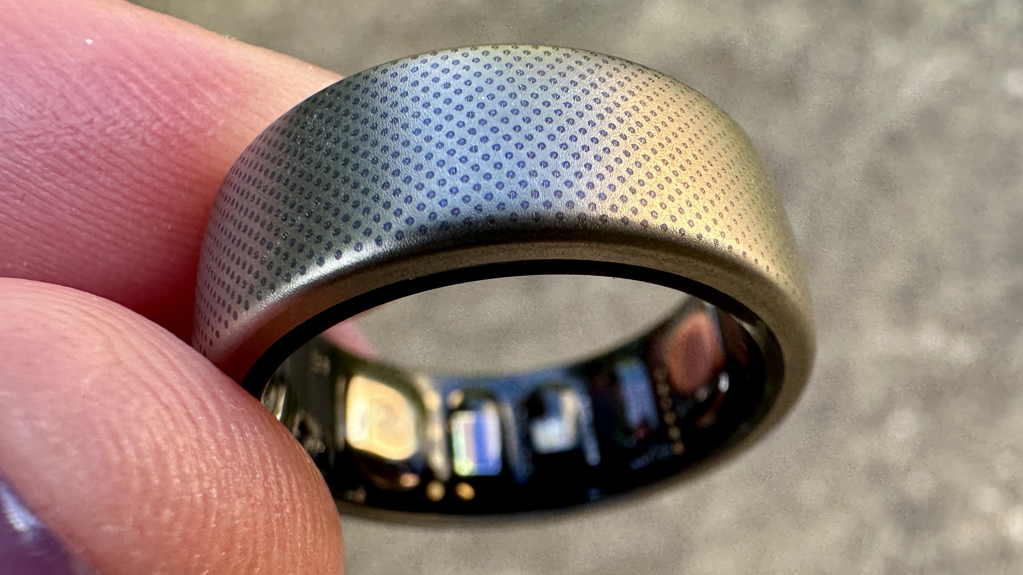 Amazfit Helio Ring closeup against a concrete background.