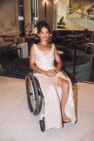 Marissa Bode in her wheelchair in a hotel lobby on her way to the Wicked premiere