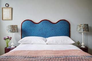 A blue headboard with red fringe
