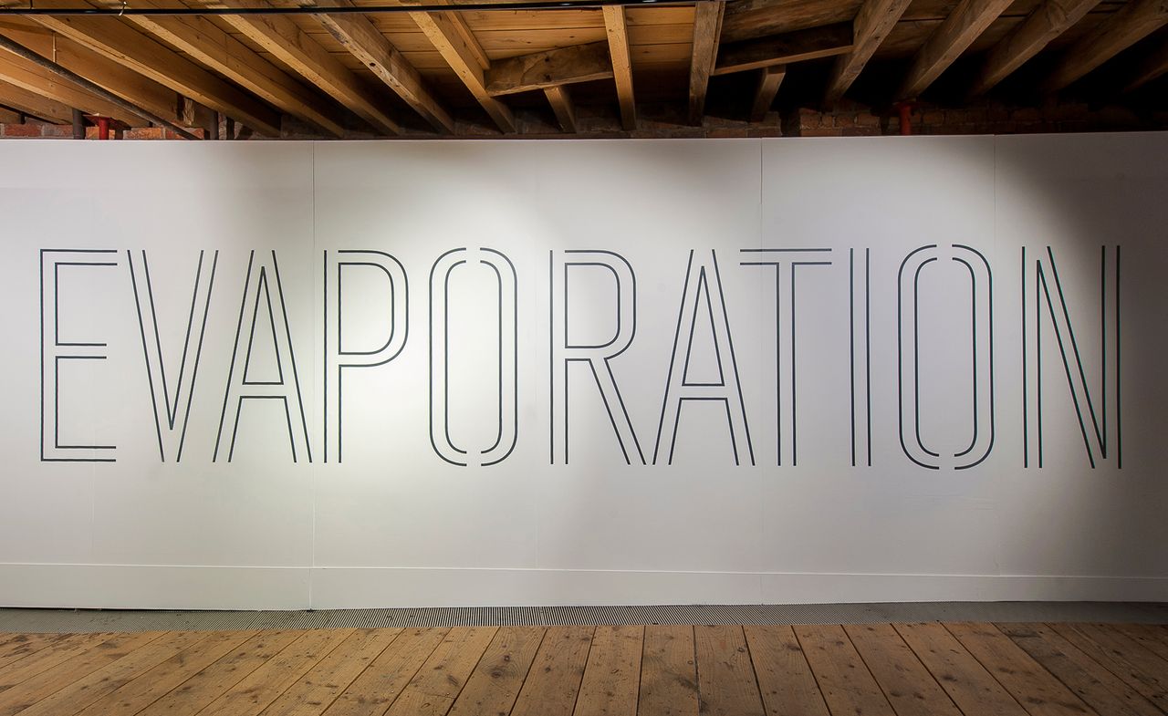 An art installation in the Manchester Museum of Science and Industry. &#039;Evaporation&#039; is written in all caps on a white board.