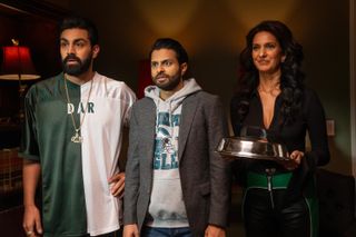 two boys in philedelphia eagles merch and poorna jagannathan as lucky holding a dog food bowl in a still from deli boys