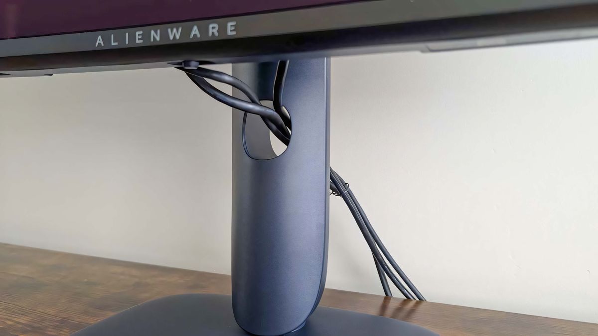 A closeup of the cables running through the hole in the Alienware 34 Curved QD-OLED AW3425DW's stand.