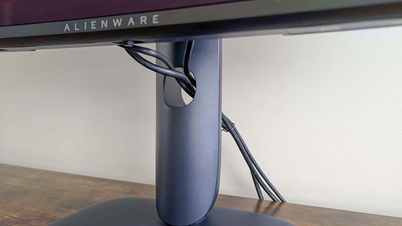 A closeup of the cables running through the hole in the Alienware 34 Curved QD-OLED AW3425DW's stand.