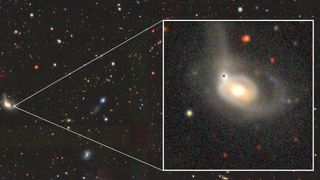 Image from the Legacy Survey DR10 of the AT 2022wtn field. The inset shows the transient that occurred in the nucleus of the interacting minor galaxy, indicated by the blue cross.