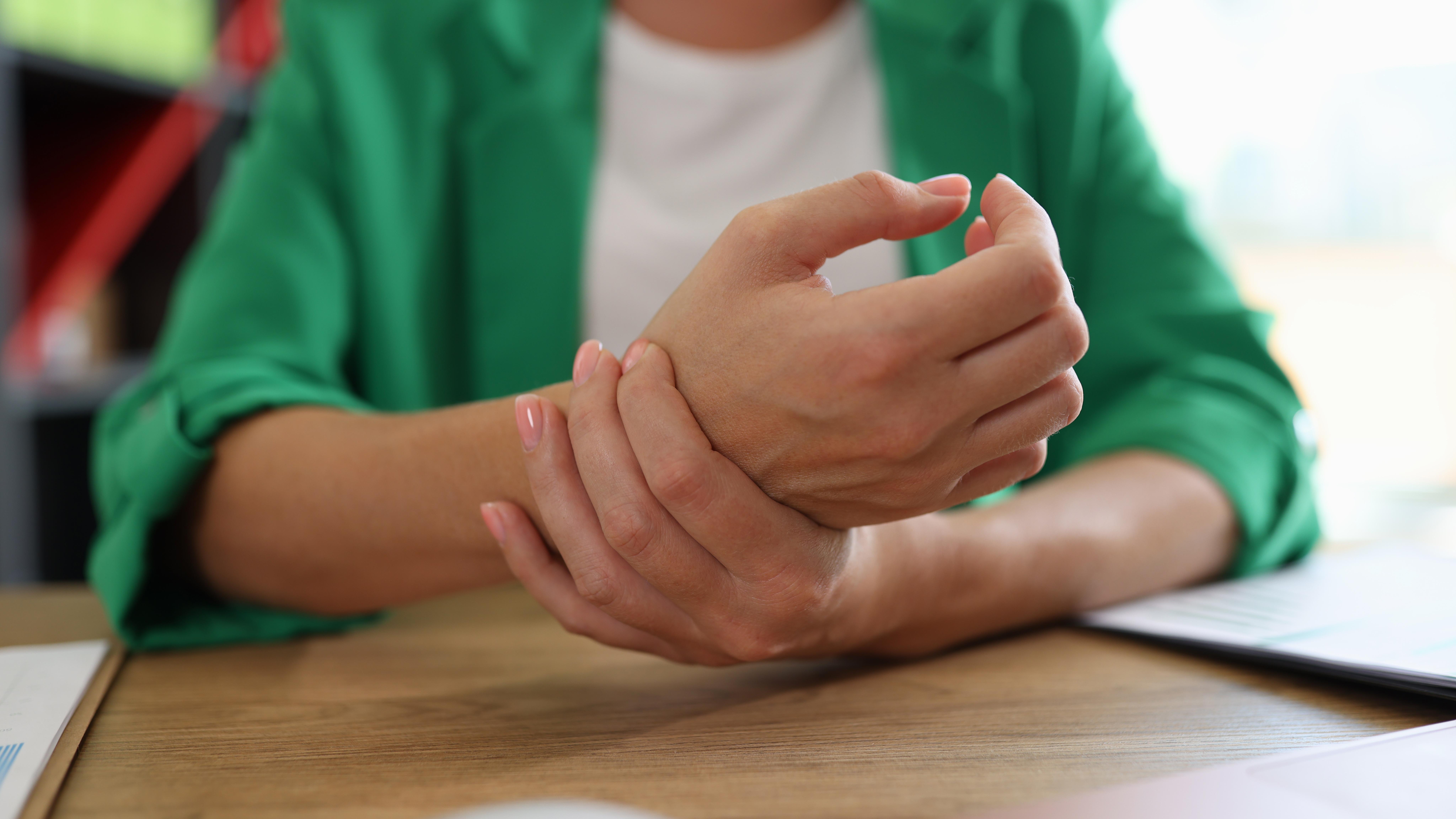 a woman holding her wrist