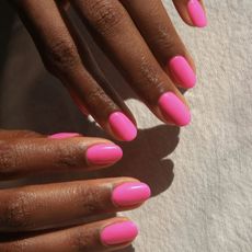 July Nail Colours @imarni nails womans hands with bright pink nails