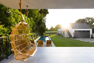 A back porch with a swing