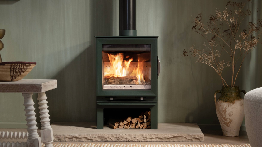 Log burner next to a plant pot and table