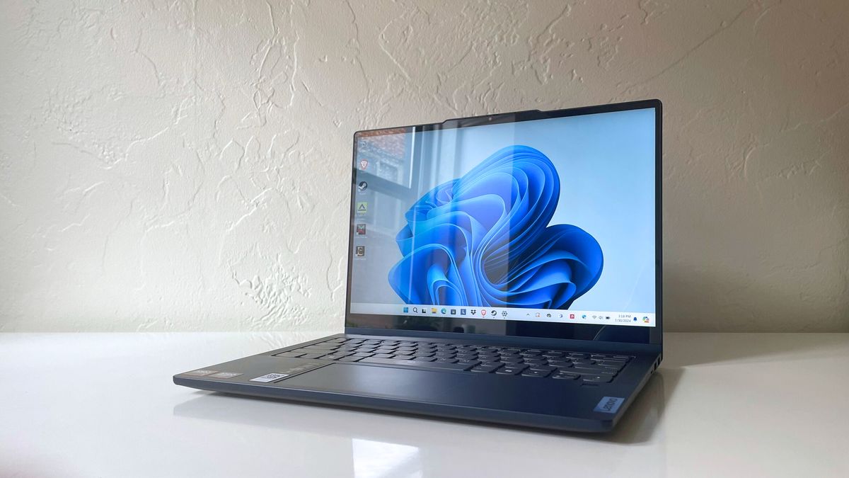 The Lenovo IdeaPad 5 2-in-1 laptop with lid open on a white table