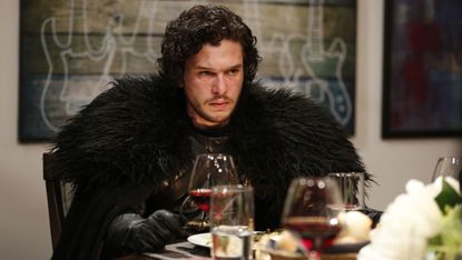 John Snow appears concerned as he sits for dinner.