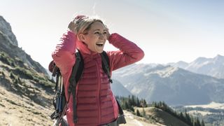 hardshell vs softshell: female hiker in insulated jacket