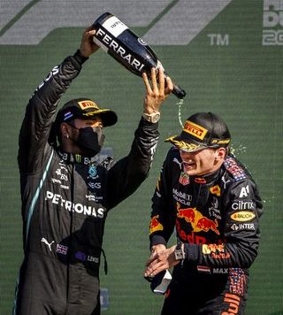 zandvoort lewis hamilton mercedes sprays champagne over max verstappen red bull after winning the dutch grand prix at the zandvoort circuit remko de waal photo by anp sport via getty images