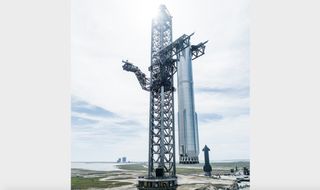 SpaceX's "Mechazilla" tower lifts the 33-engine Super Heavy Booster 7 onto the orbital launch mount on Aug. 23, 2022.