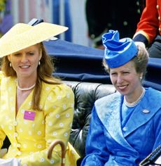 Princess Anne in a blue coat and Sarah Ferguson in a yellow dress and hat riding in a carriage at Royal Ascot 1987