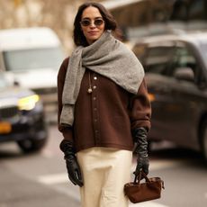a woman wearing a cashmere cardigan and jumper during fashion week
