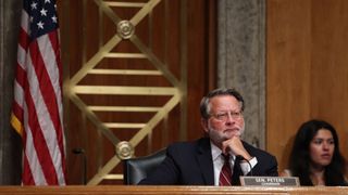 Senator Gary Peters listening at a session in government