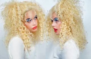 Model Kaia Gerber in a blonde curly wig