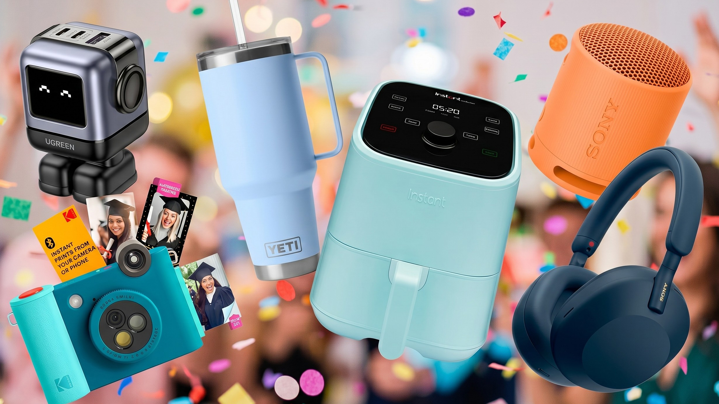 A Kodak instant print camera, charging dock, Yeti cup, Sony headphones and speaker all against a blurred background with confetti floating around