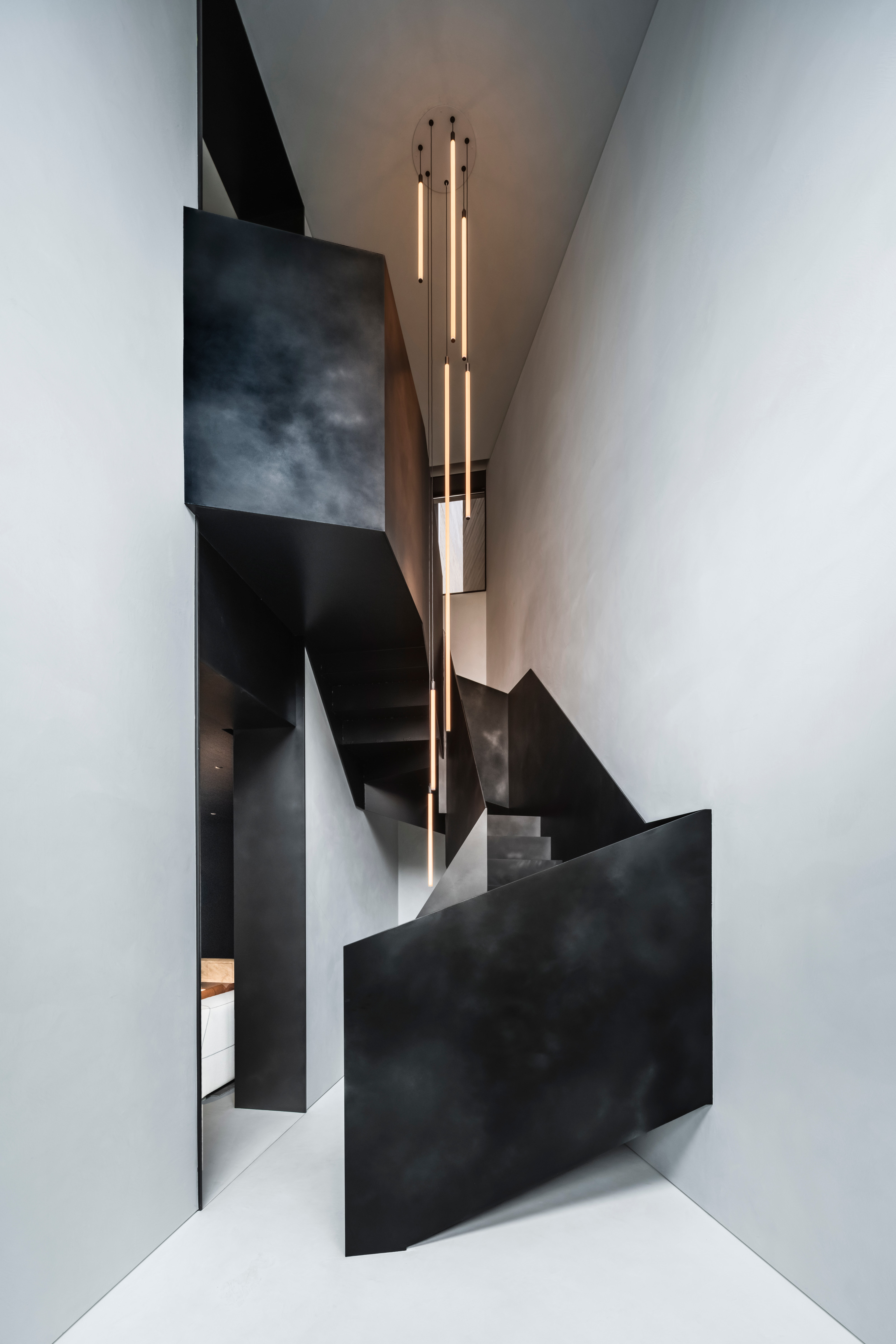 The folded steel staircase is a sculptural centrepiece of the townhouse