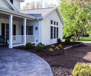 front yard with hose and mulch