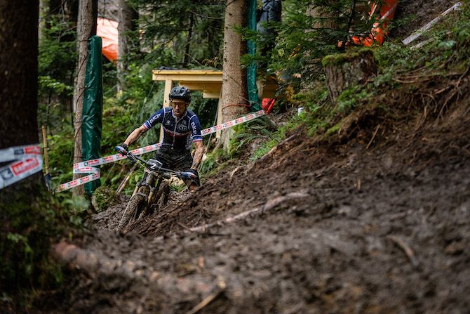 Jerome Gilloux (France) navigates a muddy, rooty corner