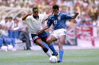 Ian Wright challenges Cafu in a friendly between England and Brazil in 1993.