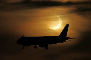 A plane flies in front of the partially eclipse sun in this stunning photo from photographers Imelda Joson and Edwin Aguirre at Black Falcon Cruise Ship Terminal in Boston on June 10, 2021.