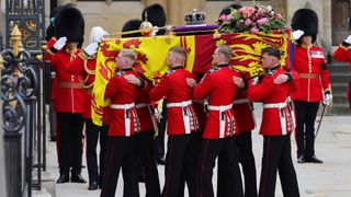 The coffin of Queen Elizabeth II with the Imperial State Crown resting on top is carried into Westminster Abbey