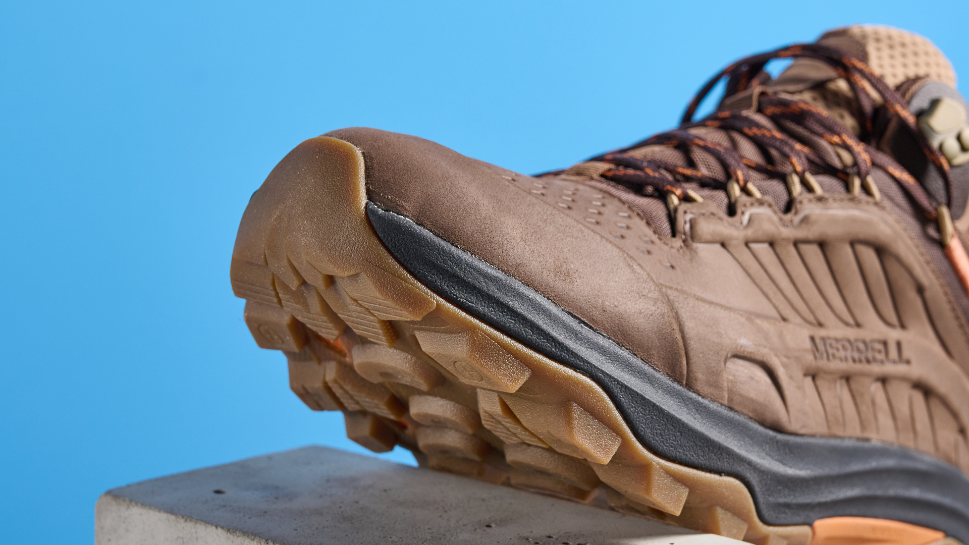 A photo of the Merrell Moab Speed 2 boots against a blue background