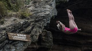 Woman diving from cliff