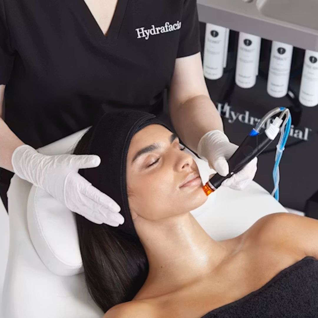 A woman receiving a hydrafacial treatment