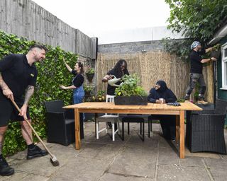 People working in a courtyard garden to makeover the space