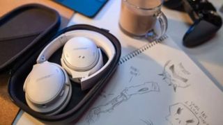 a leaked promo image of the bose quietcomfort 45 showing the headphones folded up on a desk